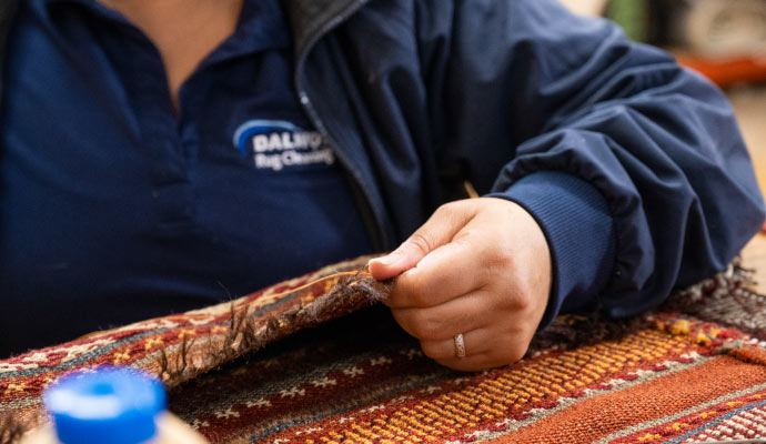 Person repairing rug