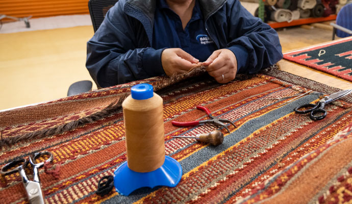 An expert repairing rug using equipment