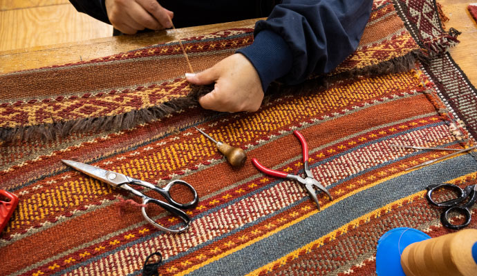 Expert repairing rug.