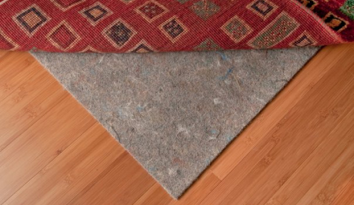 rug pad under a rug is placed on a wooden floor