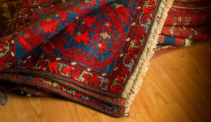 a silk rug placed on a wooden