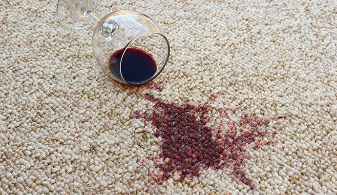 Red wine spill on a beige carpet