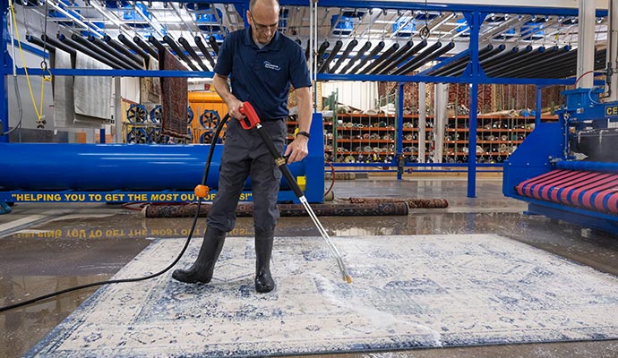 Person cleaning a rug