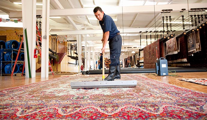 a man cleaning rug