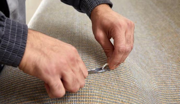 Professional worker repair rug backing