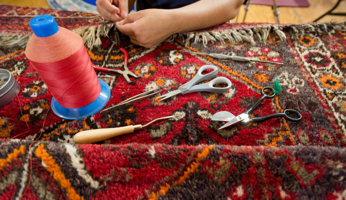 Expert repairing rug.